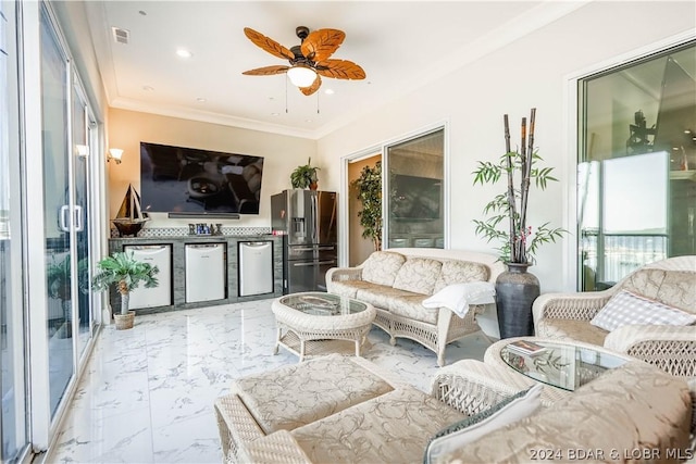 living room with ceiling fan and ornamental molding