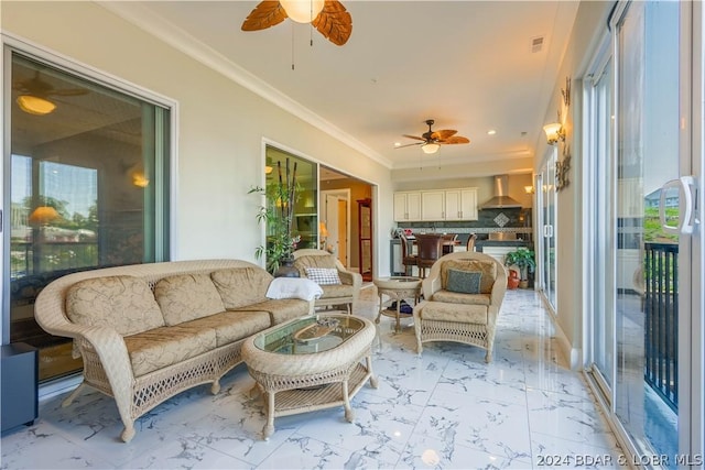 sunroom featuring ceiling fan