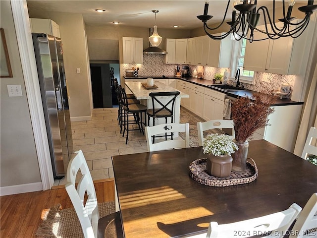 tiled dining room featuring sink and a notable chandelier