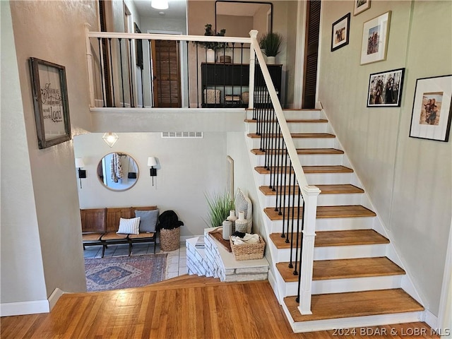 staircase featuring wood-type flooring