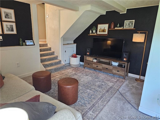 carpeted living room with lofted ceiling with beams