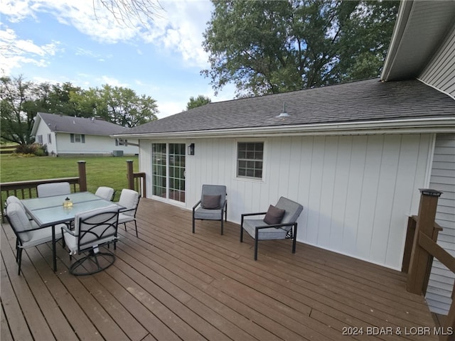 wooden terrace featuring a lawn