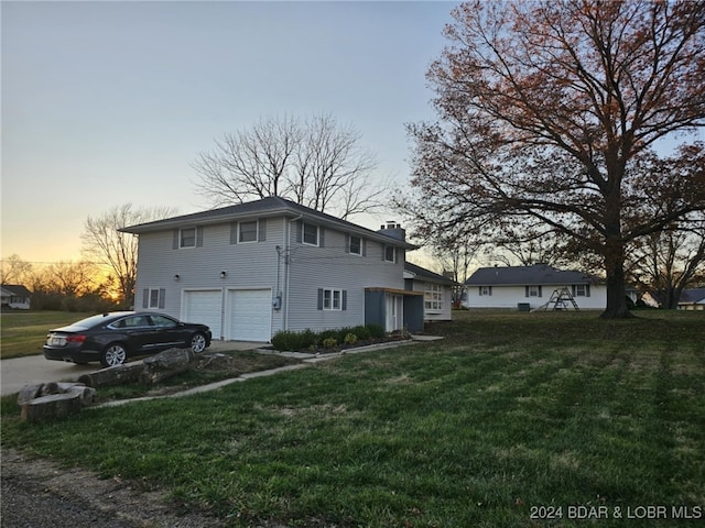 exterior space featuring a garage and a yard