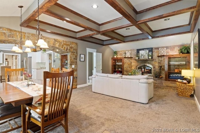 interior space featuring beam ceiling, light colored carpet, a stone fireplace, and a chandelier