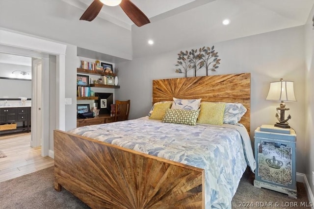 bedroom featuring ensuite bathroom, carpet floors, and ceiling fan