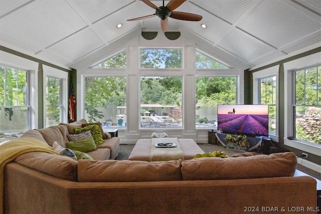 sunroom featuring ceiling fan, vaulted ceiling, and plenty of natural light