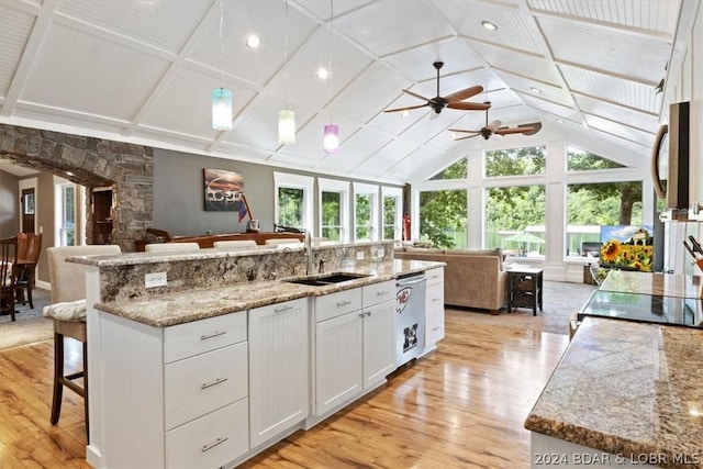 kitchen featuring a kitchen island with sink, stainless steel appliances, a breakfast bar, white cabinets, and sink