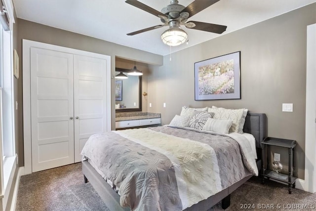 carpeted bedroom featuring ceiling fan and a closet