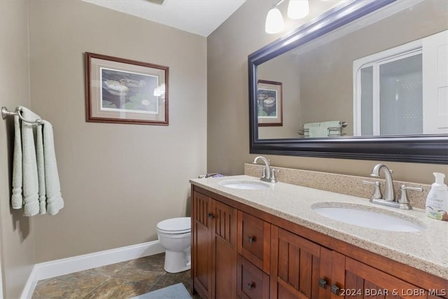 bathroom featuring toilet and vanity