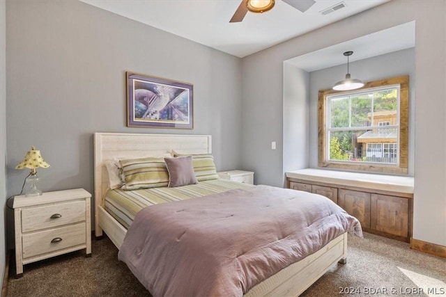 bedroom featuring dark colored carpet and ceiling fan