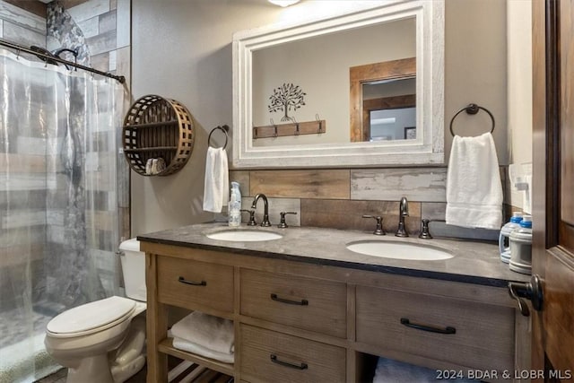 bathroom featuring vanity, curtained shower, and toilet