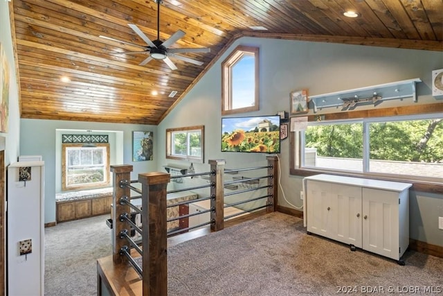 bedroom featuring wood ceiling, multiple windows, and light carpet