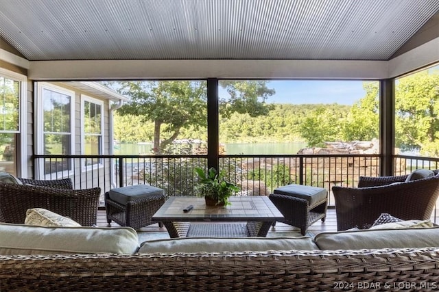 sunroom featuring vaulted ceiling and plenty of natural light