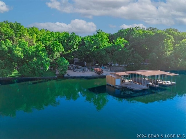 exterior space featuring a boat dock and a water view