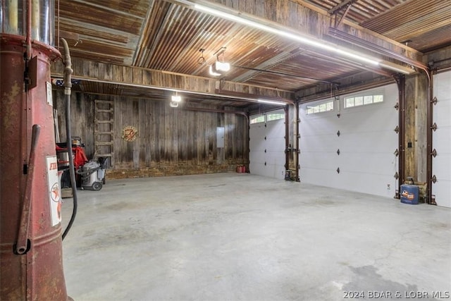 garage featuring a garage door opener and wood walls