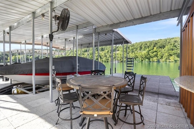 view of patio / terrace with a boat dock and a water view