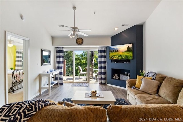 living room featuring ceiling fan and light wood-type flooring