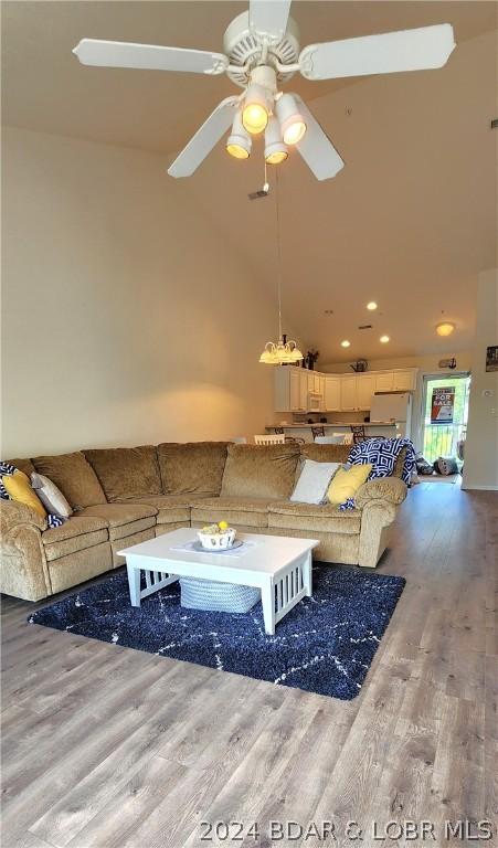 unfurnished living room with ceiling fan, light hardwood / wood-style flooring, and high vaulted ceiling