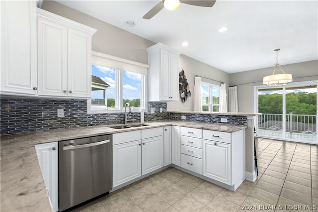 kitchen with sink, hanging light fixtures, stainless steel dishwasher, ceiling fan, and white cabinetry