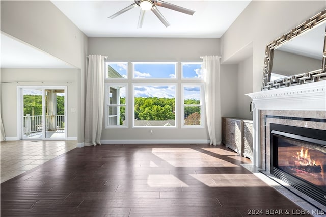 unfurnished living room featuring dark hardwood / wood-style floors and ceiling fan