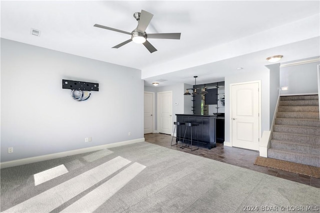 30 Southern Pine Ln, Four Seasons, MO 65049 - unfurnished living room with carpet flooring, stairway, ceiling fan, and a bar