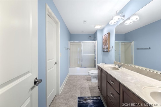 full bathroom featuring shower / bath combination with glass door, vanity, and toilet