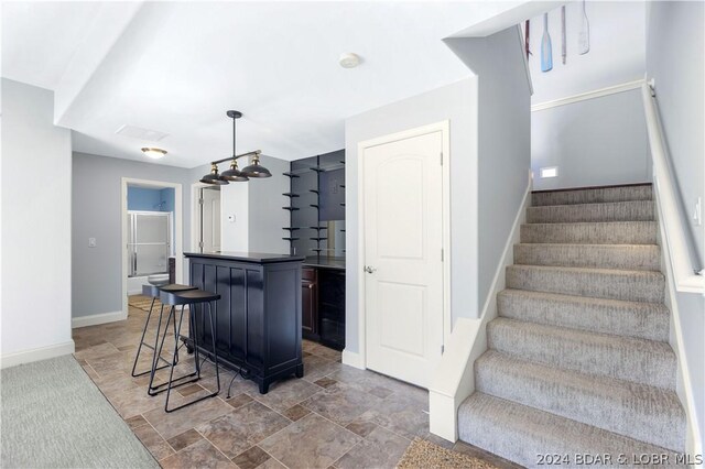 30 Southern Pine Ln, Four Seasons, MO 65049 - kitchen featuring a kitchen island, a breakfast bar, dark countertops, and pendant lighting