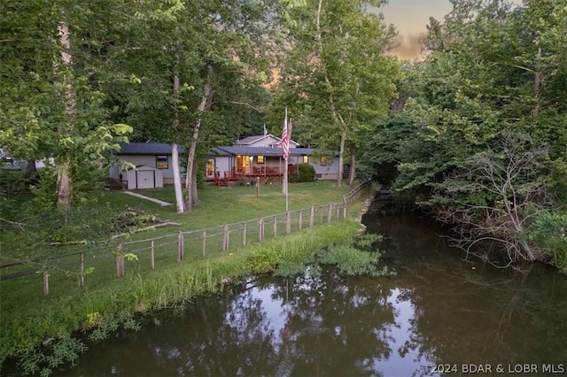 yard at dusk with a water view