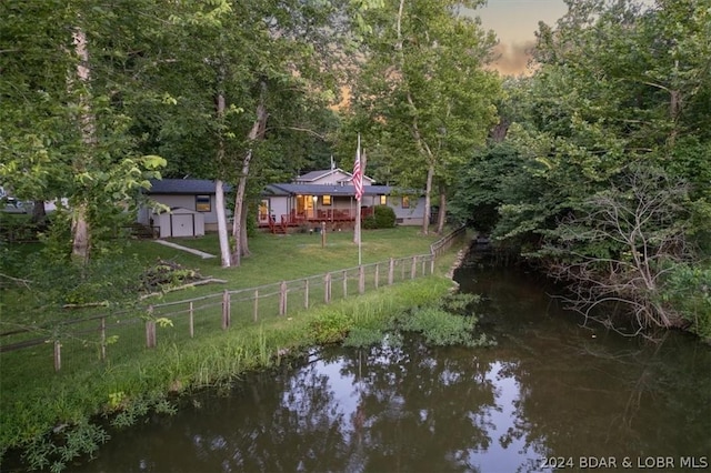 1465 Easy St, Osage Beach, MO 65065 - view of yard featuring a shed and a deck with water view
