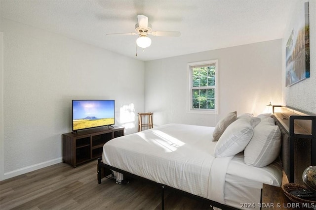 bedroom featuring a textured ceiling, ceiling fan, and hardwood / wood-style flooring