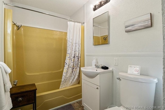 full bathroom featuring toilet, a textured ceiling, shower / tub combo with curtain, tile patterned floors, and vanity