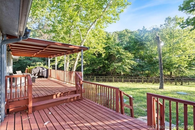 wooden terrace featuring a lawn