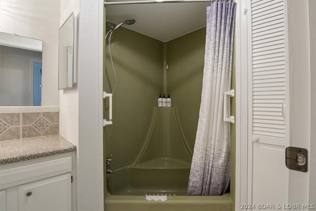 bathroom with vanity, decorative backsplash, and shower / bathtub combination with curtain