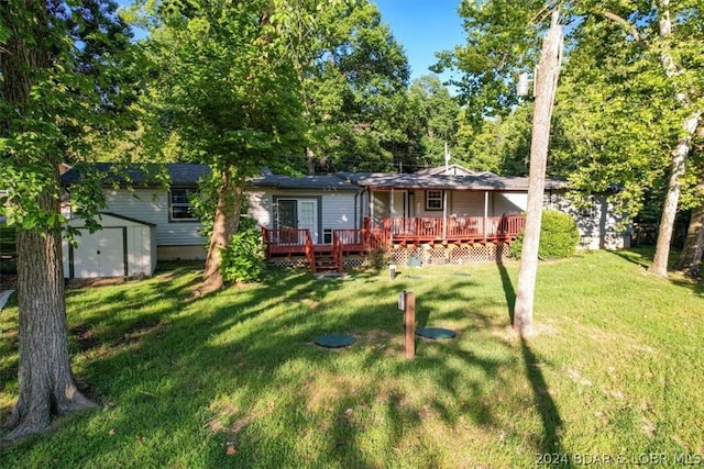 view of front of house with a storage unit, a deck, and a front lawn