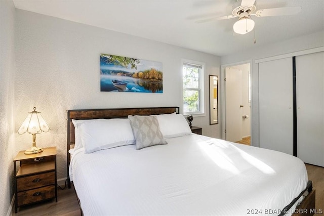 bedroom with ensuite bath, a closet, ceiling fan, and dark hardwood / wood-style floors