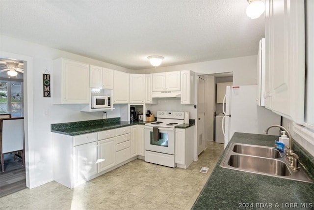 kitchen with white appliances, white cabinets, a textured ceiling, and sink