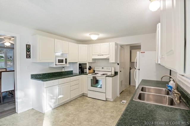 1465 Easy St, Osage Beach, MO 65065 - kitchen featuring white appliances, under cabinet range hood, white cabinets, dark countertops, and a textured ceiling