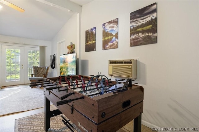 recreation room with an AC wall unit, french doors, and vaulted ceiling with beams