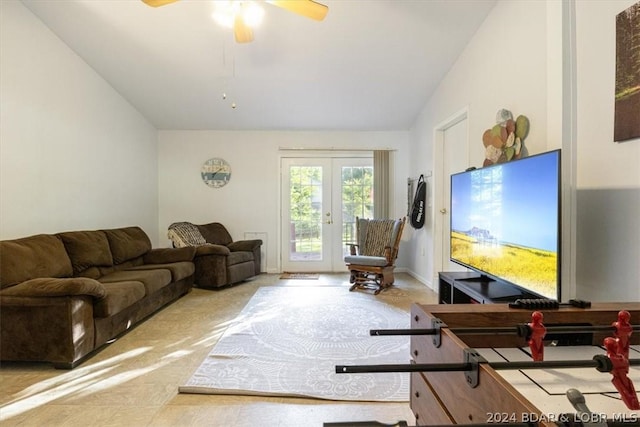 living room with ceiling fan, french doors, and vaulted ceiling