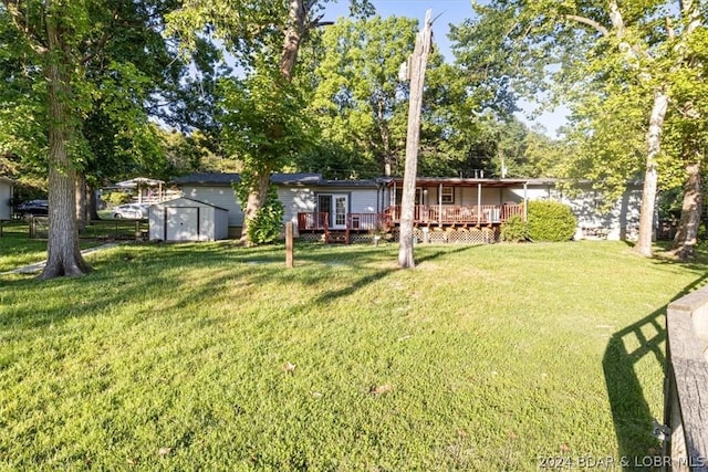 view of yard with a deck and a shed