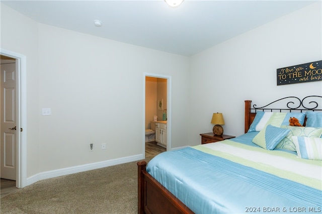 carpeted bedroom featuring ensuite bath