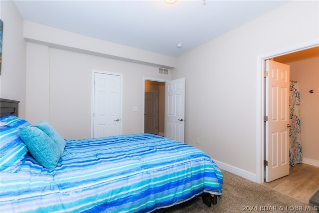 bedroom featuring light colored carpet