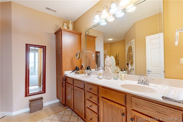 bathroom with tile patterned floors, a chandelier, and vanity