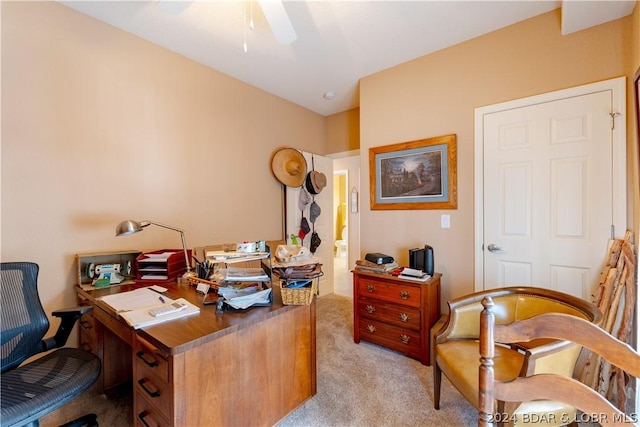 carpeted home office featuring ceiling fan