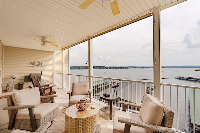 exterior space with a water view and ceiling fan