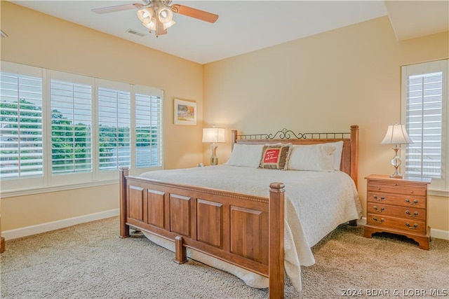 bedroom with ceiling fan and light carpet