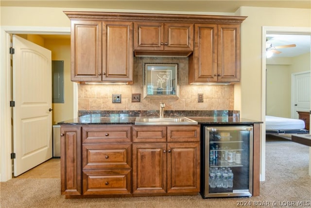 kitchen featuring wine cooler, light colored carpet, ceiling fan, sink, and backsplash