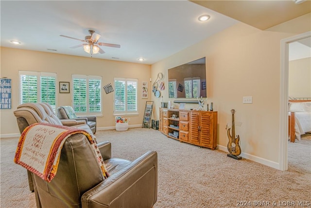 carpeted living room featuring ceiling fan