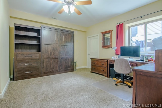 carpeted office featuring ceiling fan