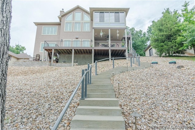 back of property with ceiling fan